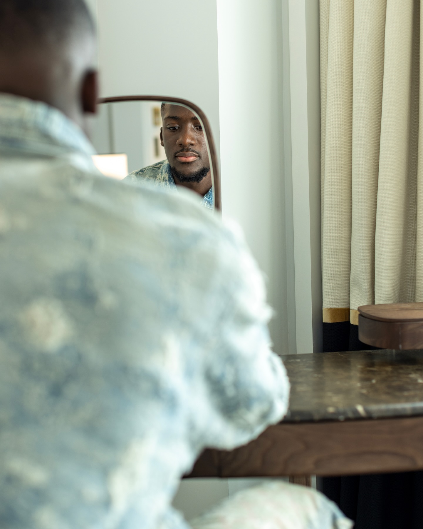 Ibrahima Konate looks dashing with a French romantic style in a denim outfit featuring white distressed accents