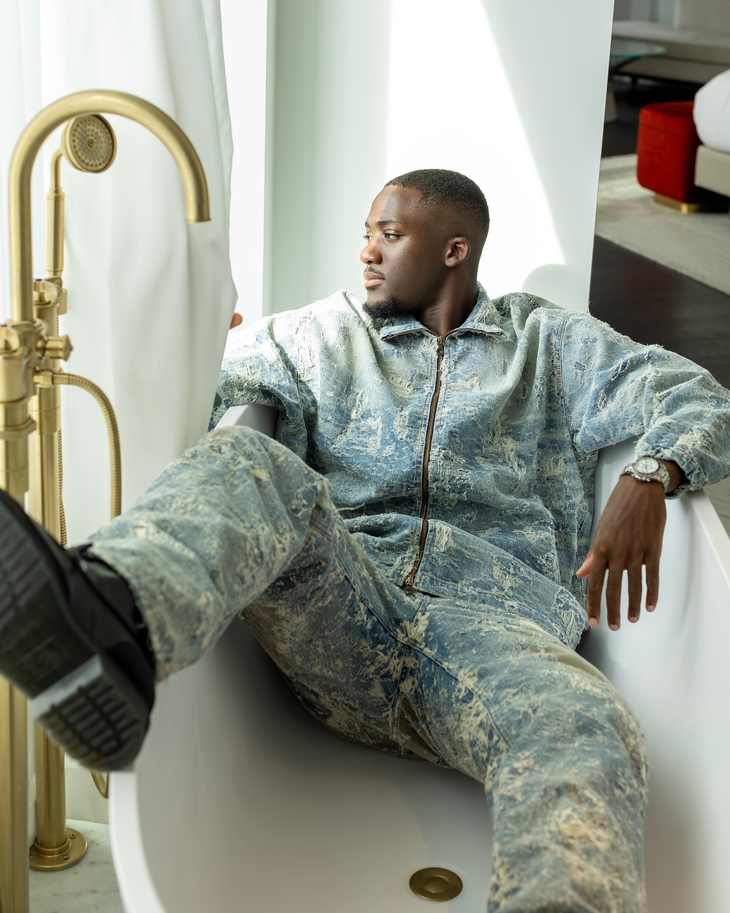 Ibrahima Konate looks dashing with a French romantic style in a denim outfit featuring white distressed accents